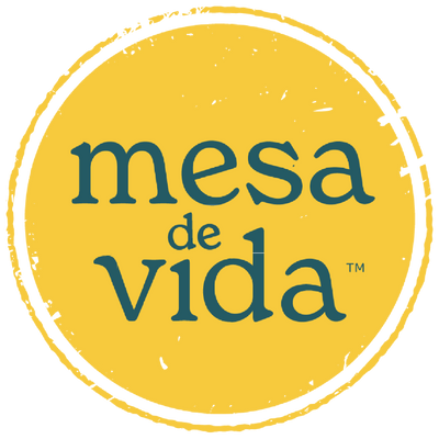 Mesa de Vida logo - a gold circle (nodding to the sun, a passport stamp, or a round table) with the words "Mesa de Vida" in teal